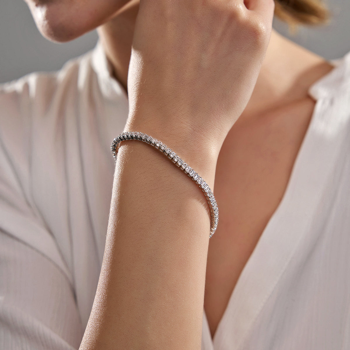 5 ctw round moissanite tennis bracelet in rhodium-plated 925 sterling silver worn on wrist